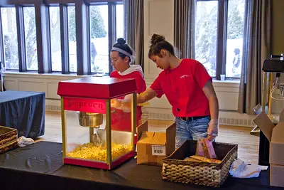 two women making popcorn
