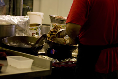 A bustling kitchen with a man at the stove