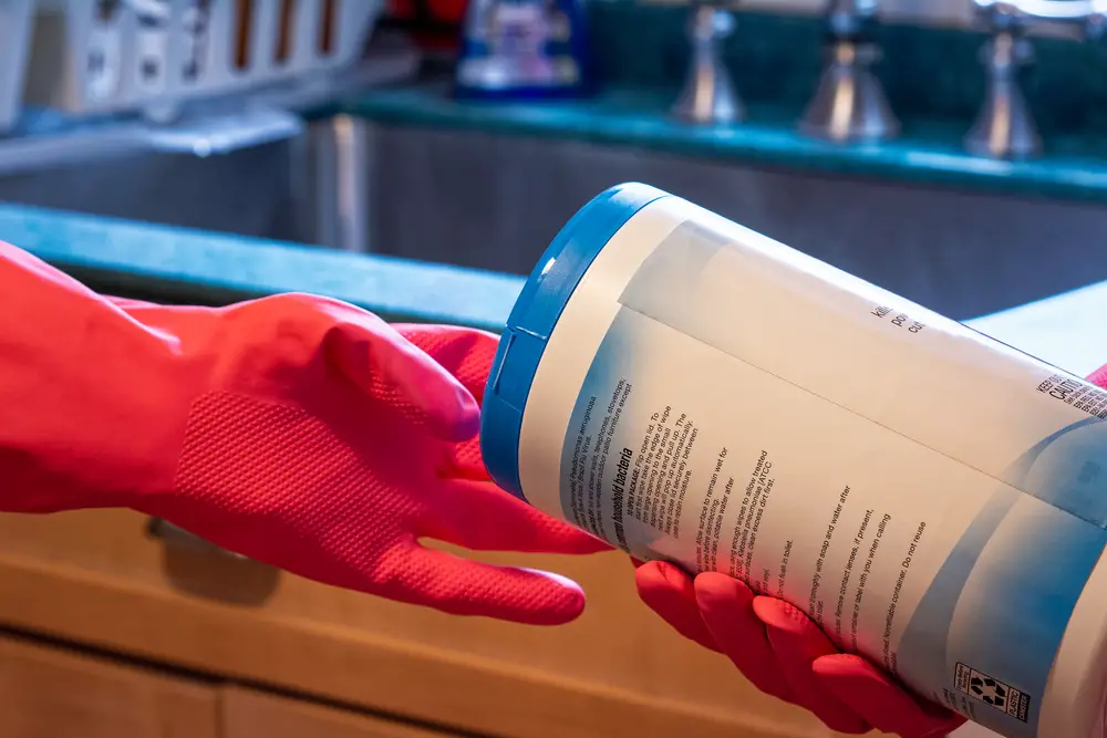 a-pair-of-hand-wearing-red-gloves-while-cleaning-the-kitchen-sink