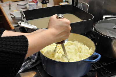 a woman mashing the veg