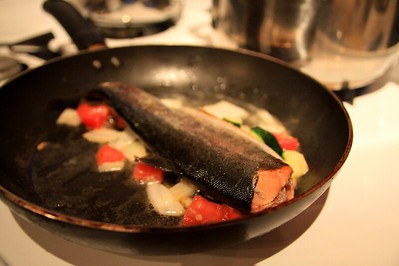 cooking fish with some vegetables