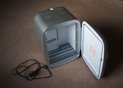 A small refrigerator in the floor