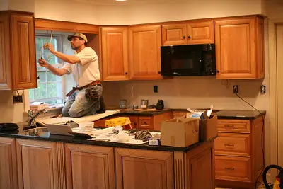 a man fixing the cupboards