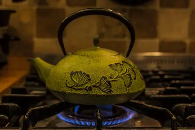 a french tea pot on the stove