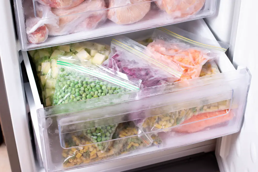 assortment of frozen vegetables in home fridge