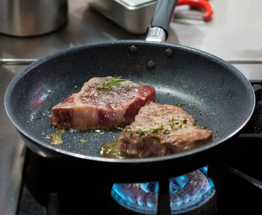 Frying meat in the kitchen