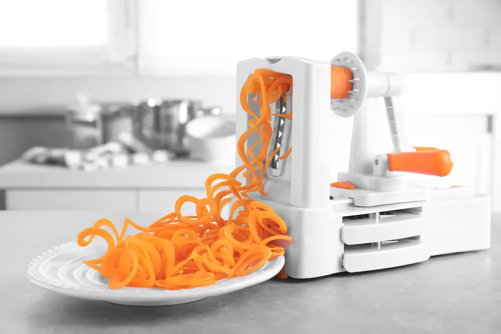 Making carrot spaghetti using a slicer